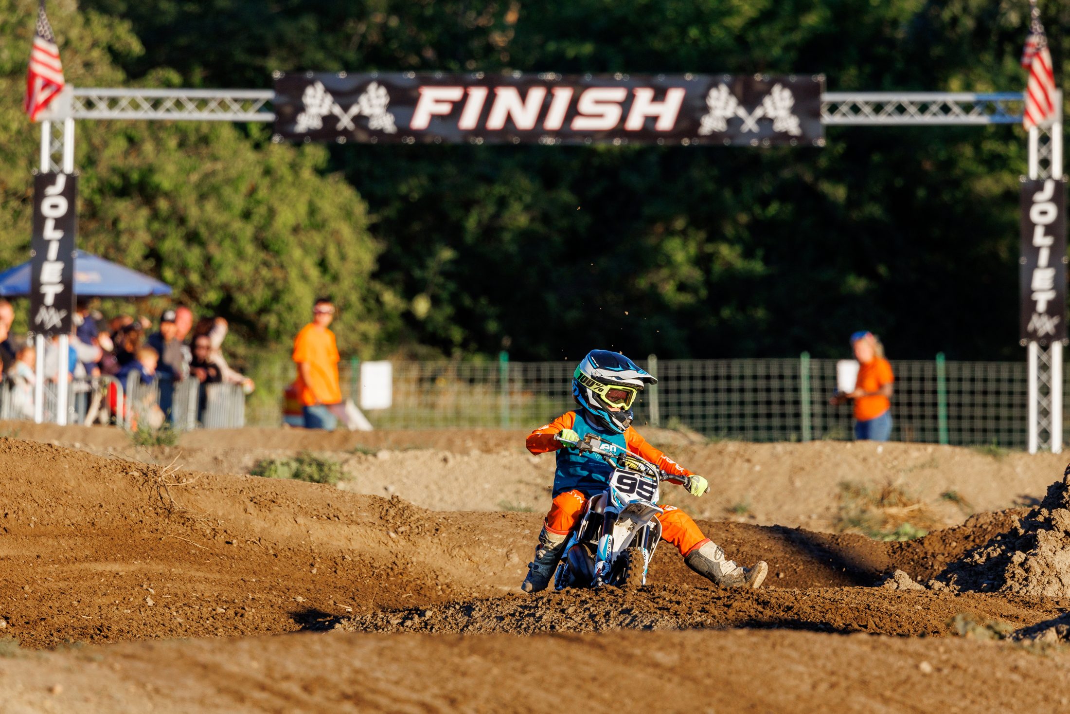 Rider cornering beneath the Joliet MX finish line